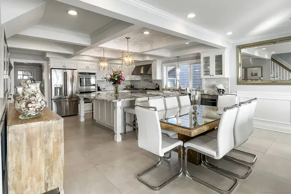 a large kitchen with lots of counter space dining table and chairs