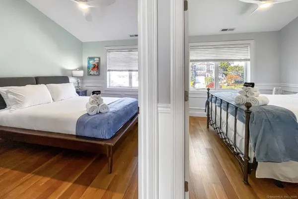 a bedroom with furniture and a wooden floor