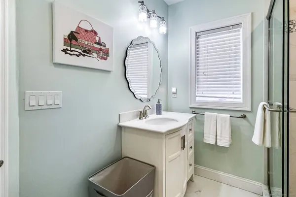 a bathroom with a sink a vanity and a mirror