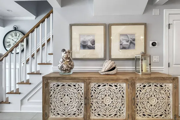 a view of a hallway to a livingroom with furniture wooden floor and front door