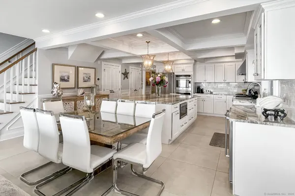 a large kitchen with lots of counter space dining table and chairs
