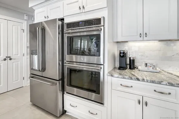 a kitchen with granite countertop stainless steel appliances and cabinets