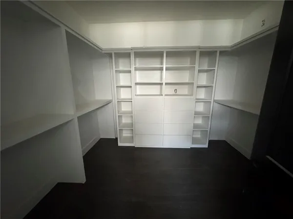 a view of a room with wooden floor and a window
