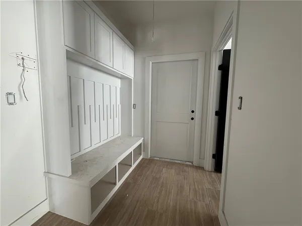 a view of an entryway with wooden floor
