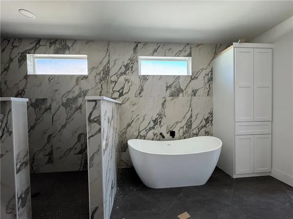 a white bath tub sitting in a bathroom