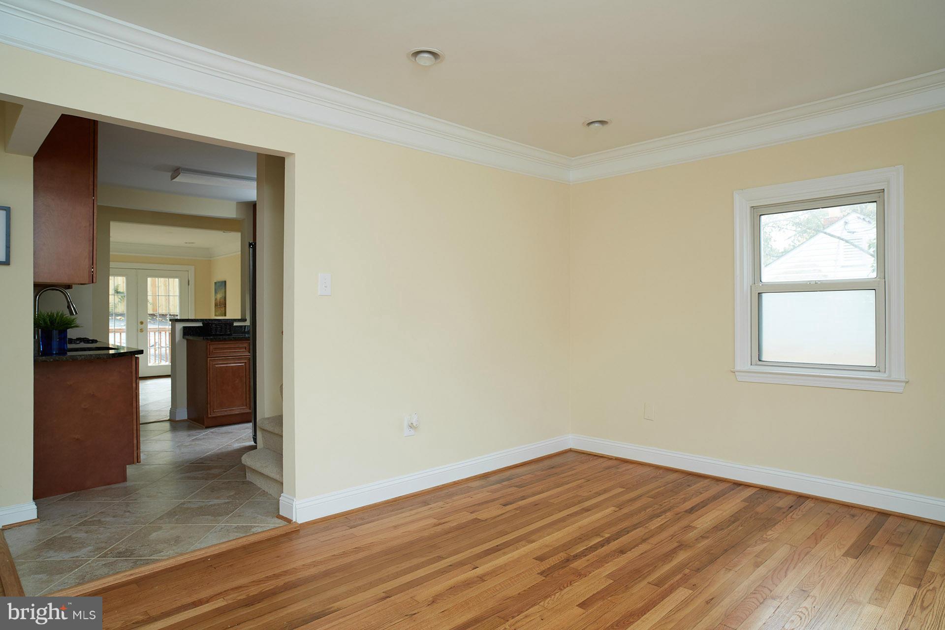 11805 Dewey Road Silver Spring, MD 20906 - Photo 11 of 30 a view of a room with wooden floor and a kitchen
