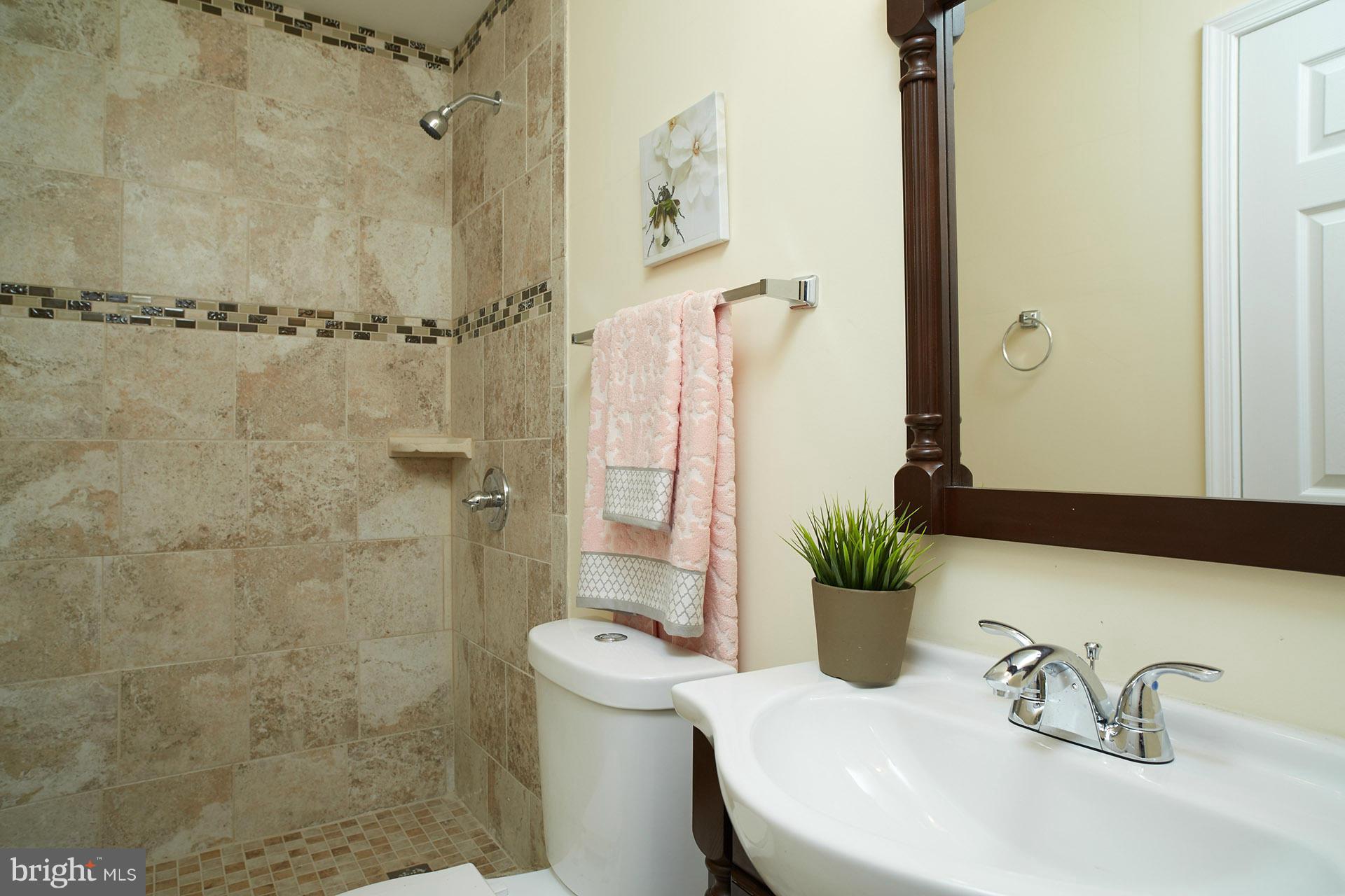 11805 Dewey Road Silver Spring, MD 20906 - Photo 12 of 30 a bathroom with a sink toilet and shower