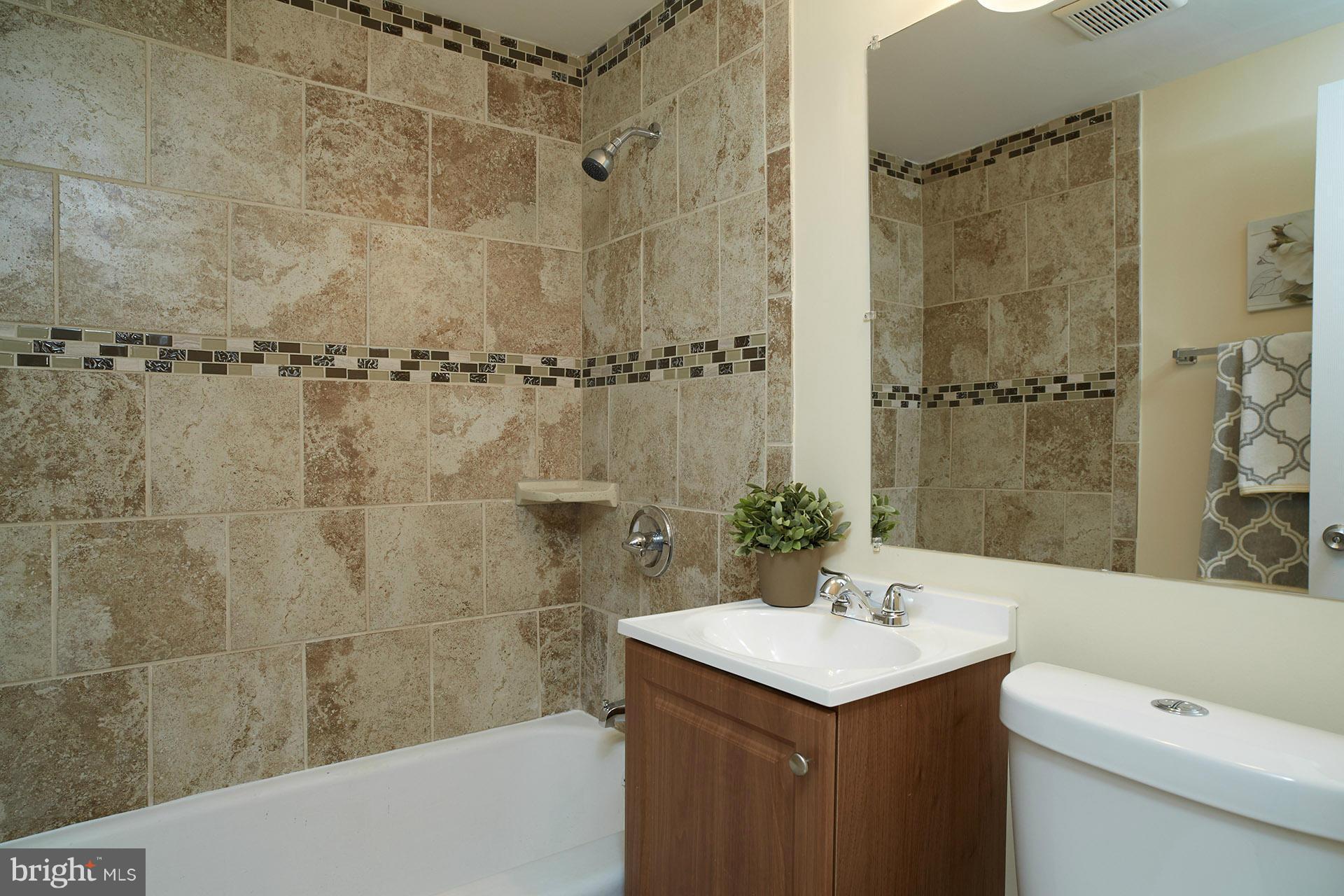 11805 Dewey Road Silver Spring, MD 20906 - Photo 15 of 30 a bathroom with a sink a toilet and shower