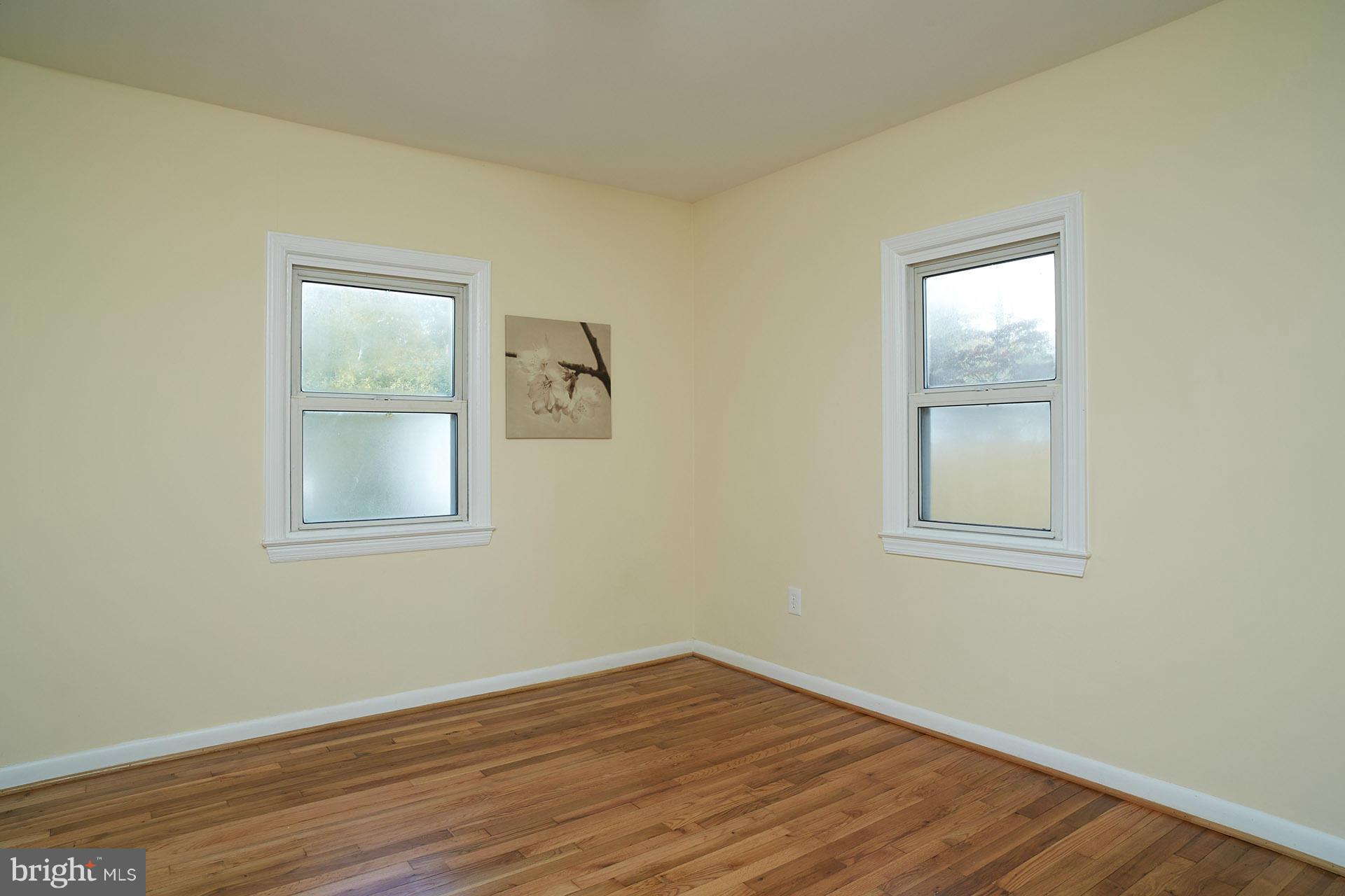 11805 Dewey Road Silver Spring, MD 20906 - Photo 19 of 30 a view of an empty room with wooden floor and a window