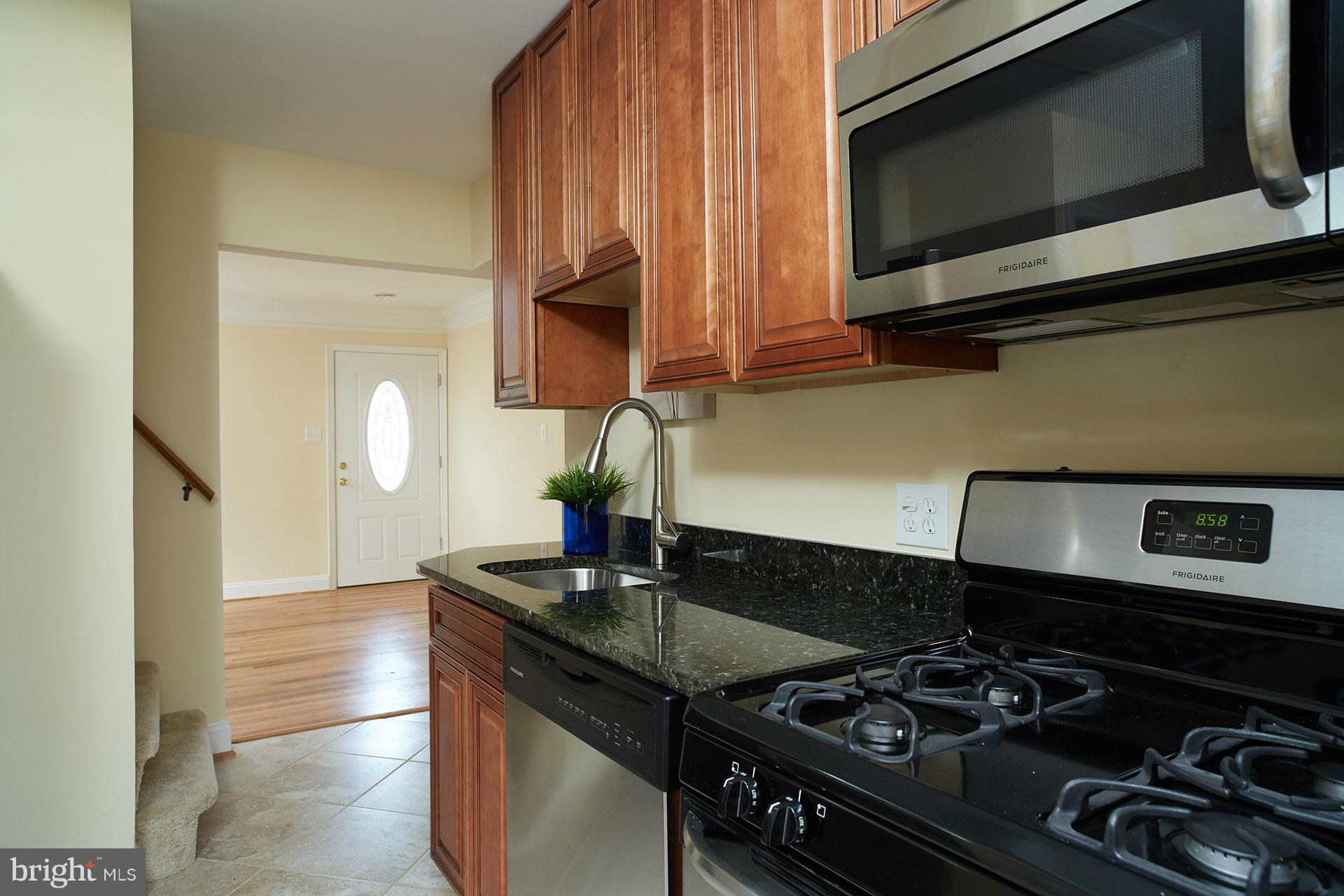 11805 Dewey Road Silver Spring, MD 20906 - Photo 5 of 30 a kitchen with a stove and a microwave