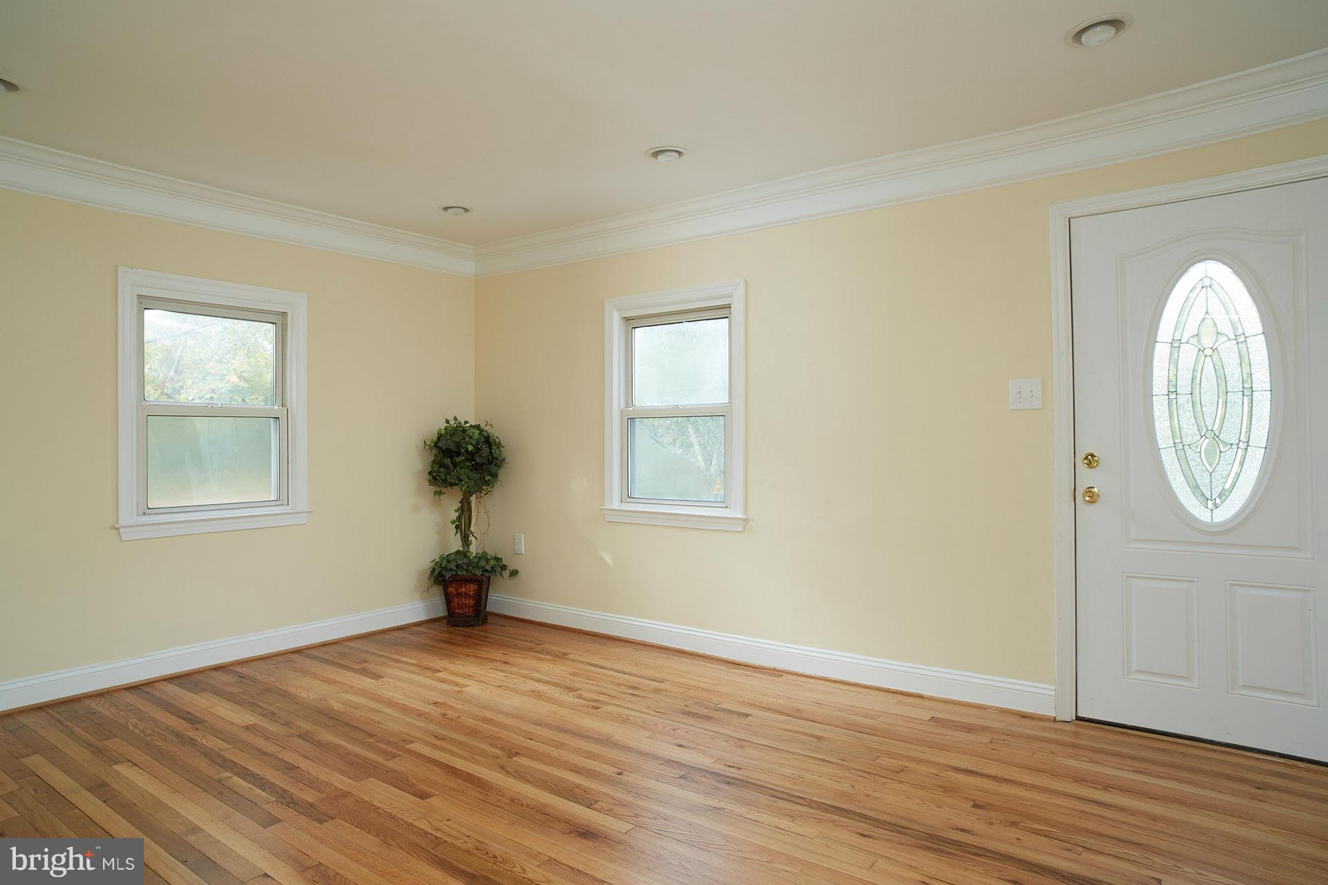 11805 Dewey Road Silver Spring, MD 20906 - Photo 9 of 30 a view of empty room with wooden floor and fan