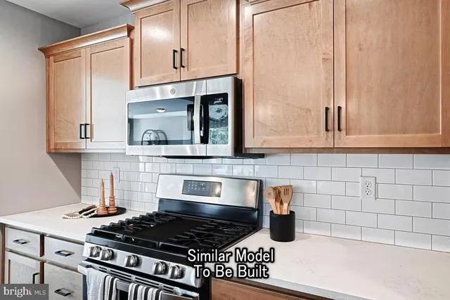 a kitchen with granite countertop a stove sink and cabinets