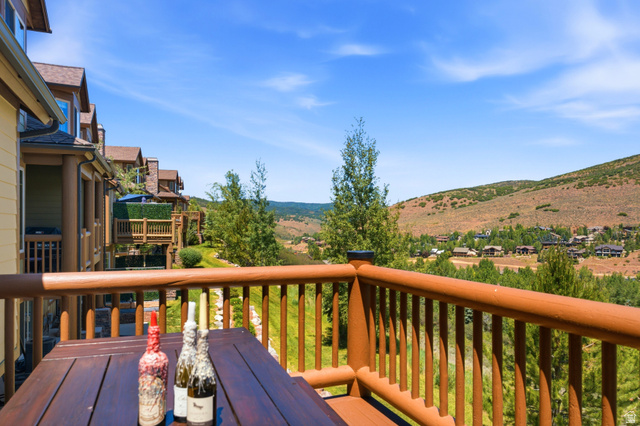 3148 Lower Saddleback Road Park City, UT 84098 - Photo 28 of 67 Outdoor deck with wood railings and a wood-finish table, overlooking a hillside community