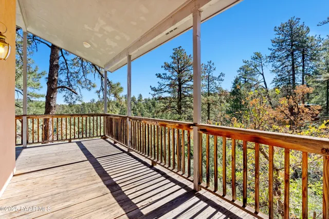a balcony with wooden floor and fence