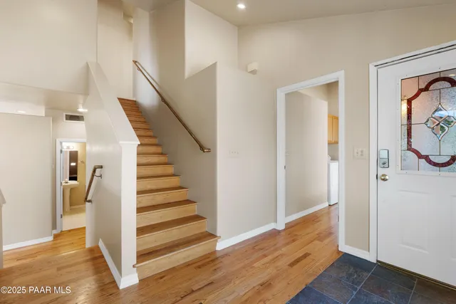a view of entryway and hall with wooden floor