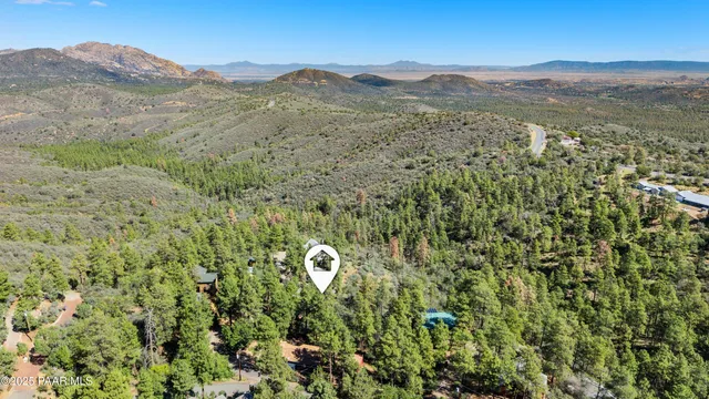 a view of a mountain with a lush green forest