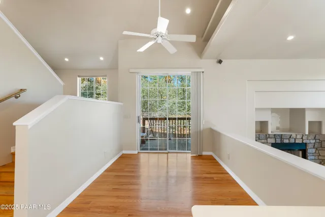 a hallway with windows and wooden floor
