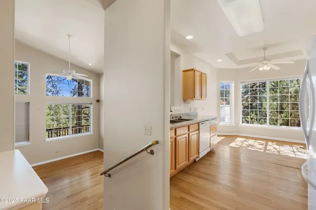 a large kitchen with lot of counter space and wooden floor