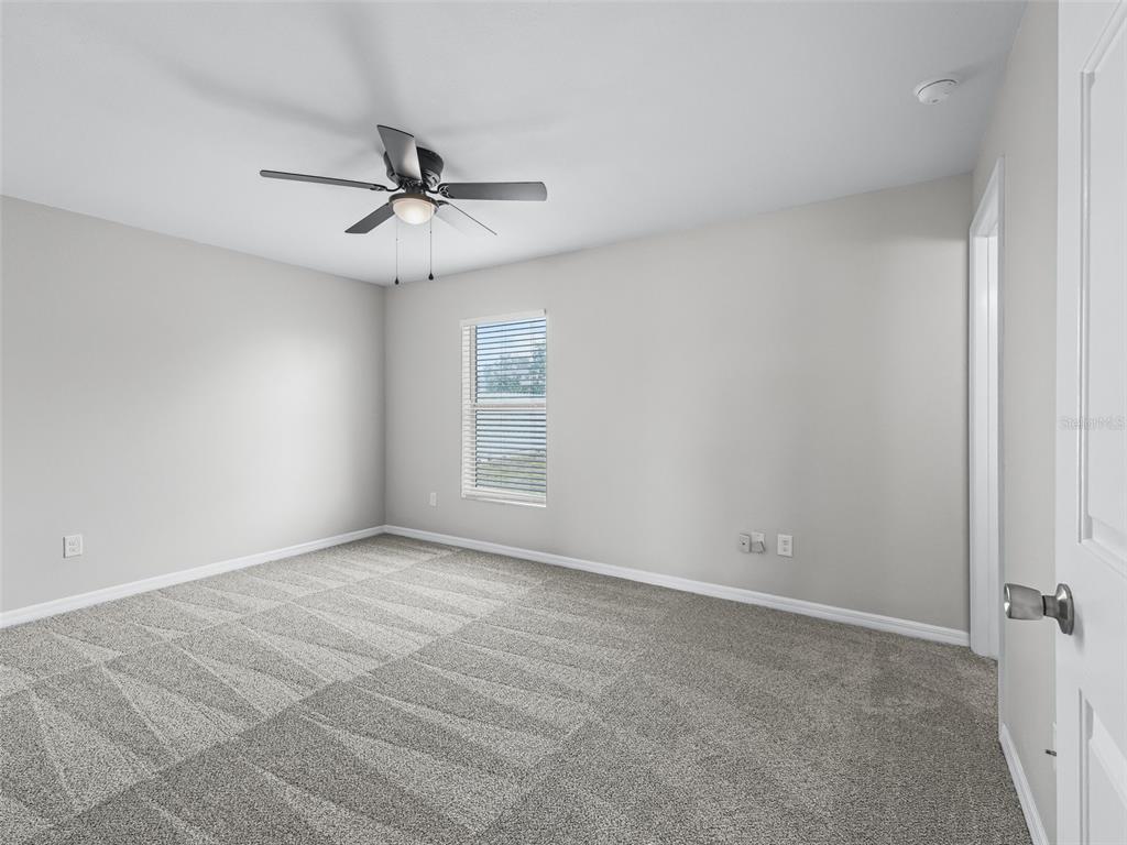27 Juniper Loop Terrace Ocala, FL 34480 - Photo 15 of 35 an empty room with windows and fan