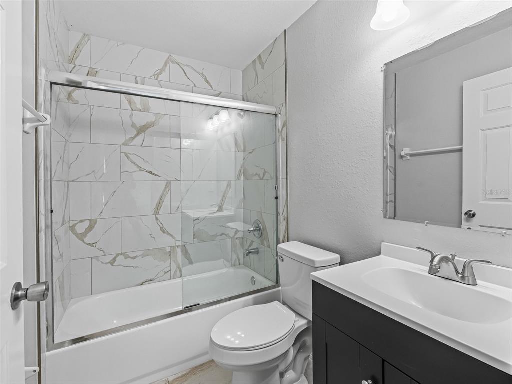 27 Juniper Loop Terrace Ocala, FL 34480 - Photo 17 of 35 a bathroom with a sink a toilet and shower