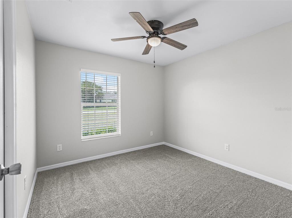 27 Juniper Loop Terrace Ocala, FL 34480 - Photo 19 of 35 an empty room with a window and a fan