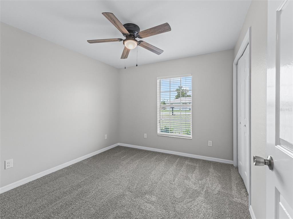 27 Juniper Loop Terrace Ocala, FL 34480 - Photo 21 of 35 a view of a big room with a ceiling fan and windows