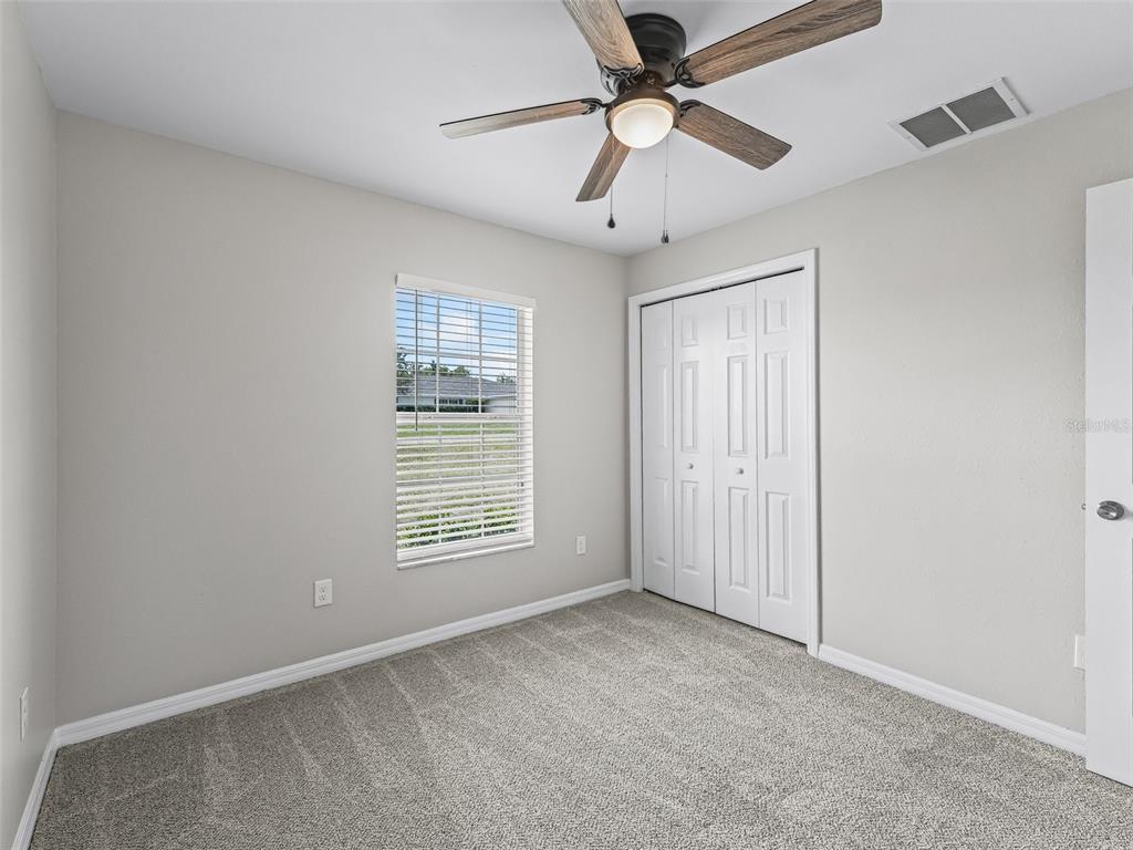 27 Juniper Loop Terrace Ocala, FL 34480 - Photo 22 of 35 an empty room with windows and fan