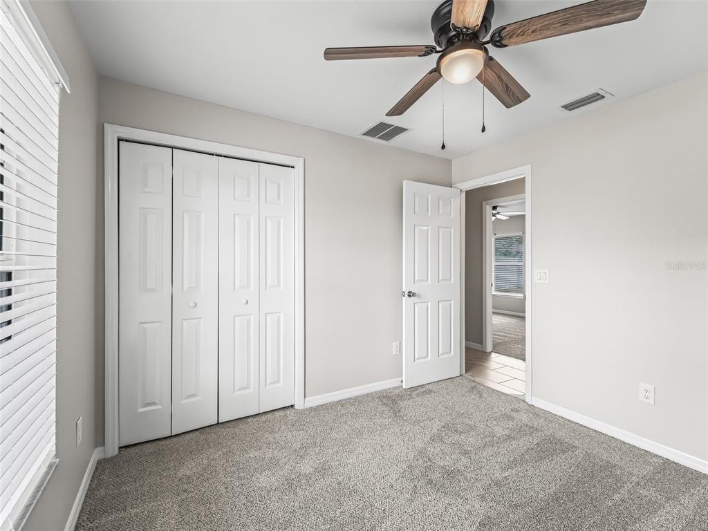 27 Juniper Loop Terrace Ocala, FL 34480 - Photo 23 of 35 an empty room with windows and fan