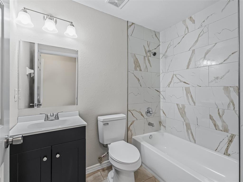 27 Juniper Loop Terrace Ocala, FL 34480 - Photo 24 of 35 a bathroom with a sink a toilet and a bathtub