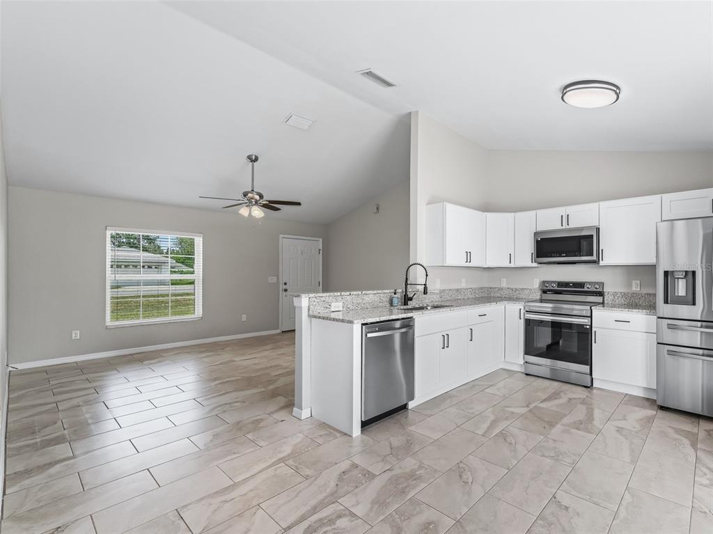 27 Juniper Loop Terrace Ocala, FL 34480 - Photo 10 of 35 a kitchen with a stove top oven sink and cabinets