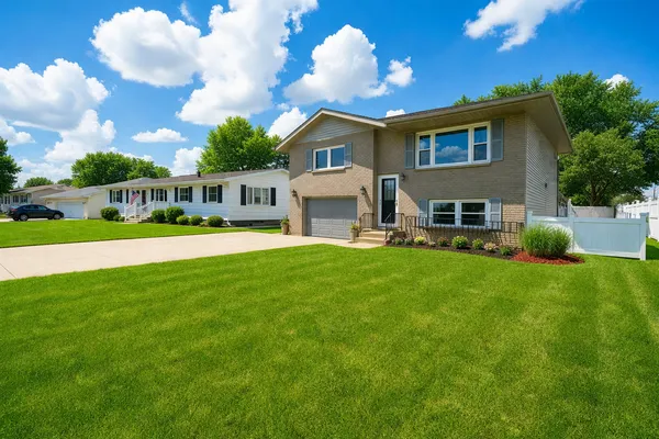 a kitchen with stainless steel appliances granite countertop a table chairs refrigerator and microwave