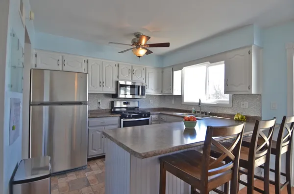 a stove top oven sitting inside of a kitchen