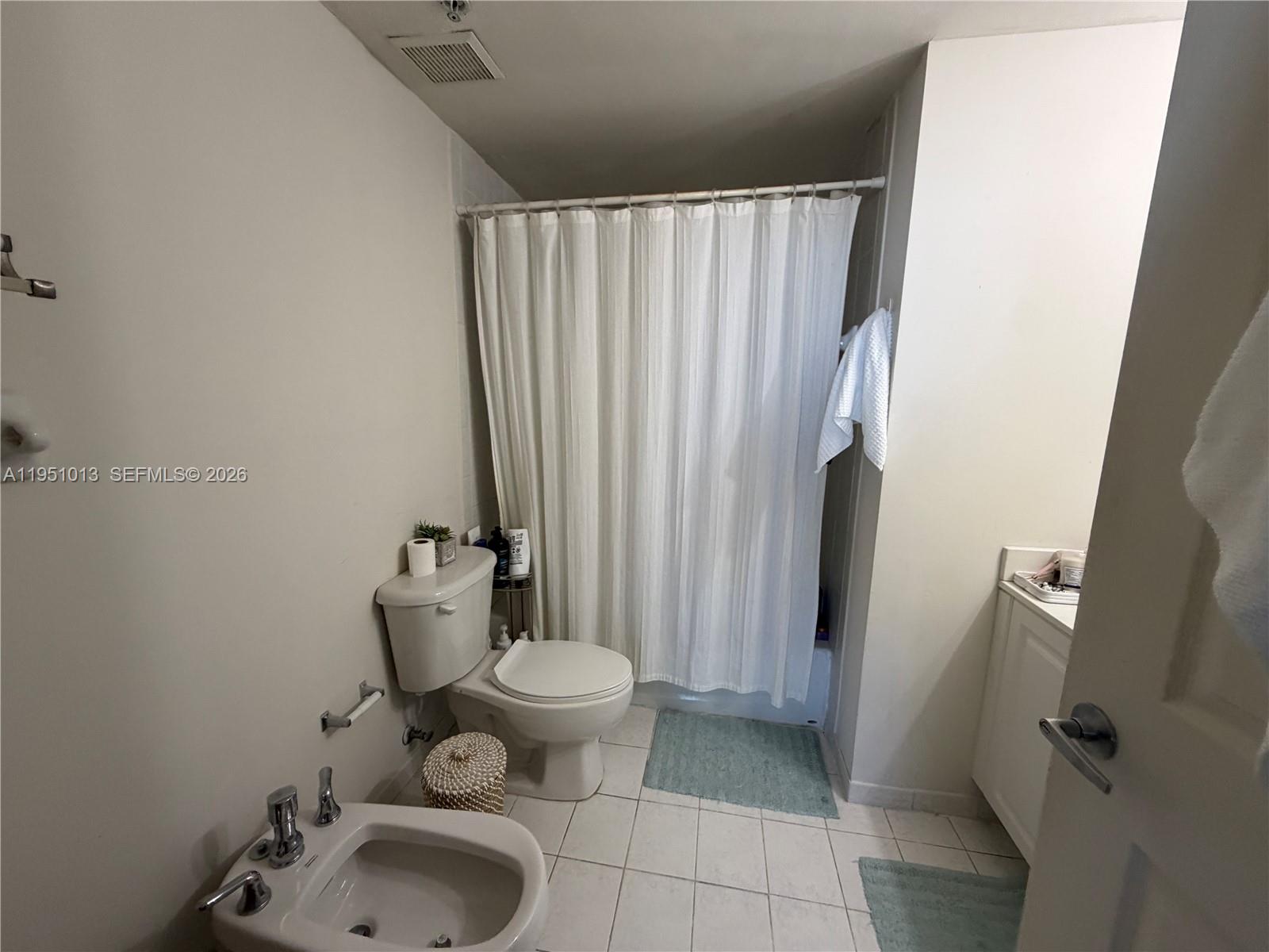 215 Southwest 42nd Avenue, Unit 803 Miami, FL 33134 - Photo 11 of 20 a bathroom with a sink toilet and shower