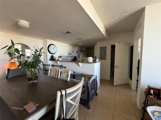 a kitchen with a refrigerator a stove a sink and cabinets