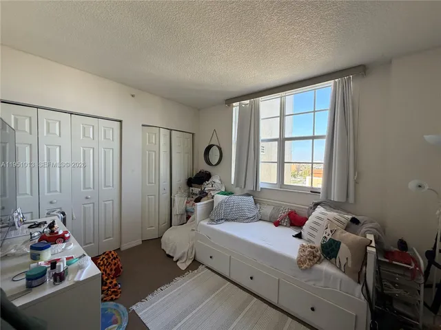 a bed room with a bed and a window