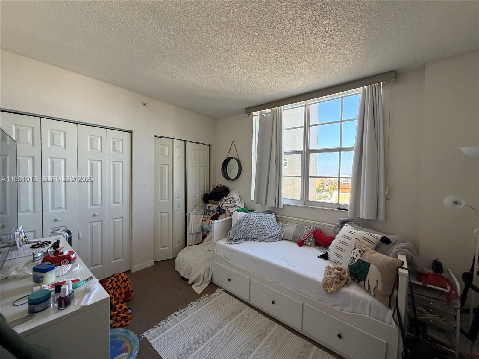 215 Southwest 42nd Avenue, Unit 803 Miami, FL 33134 - Photo 17 of 20 a bedroom with bed and a window