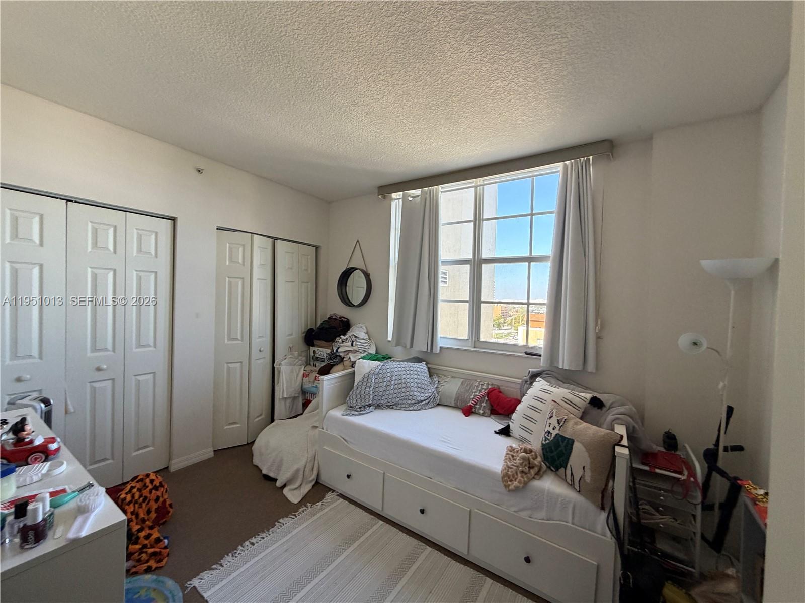 215 Southwest 42nd Avenue, Unit 803 Miami, FL 33134 - Photo 18 of 20 a bed room with a bed and a window