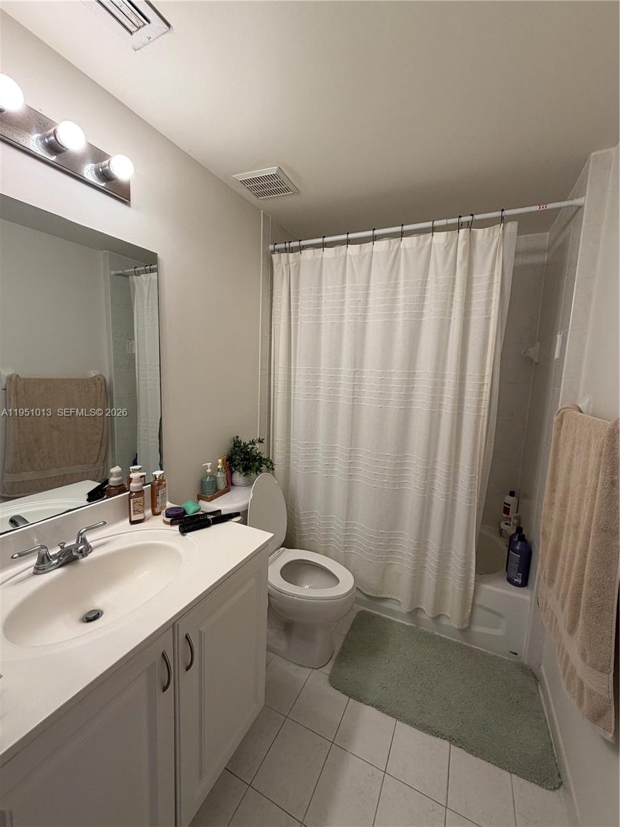 215 Southwest 42nd Avenue, Unit 803 Miami, FL 33134 - Photo 20 of 20 a bathroom with a sink a toilet and a mirror