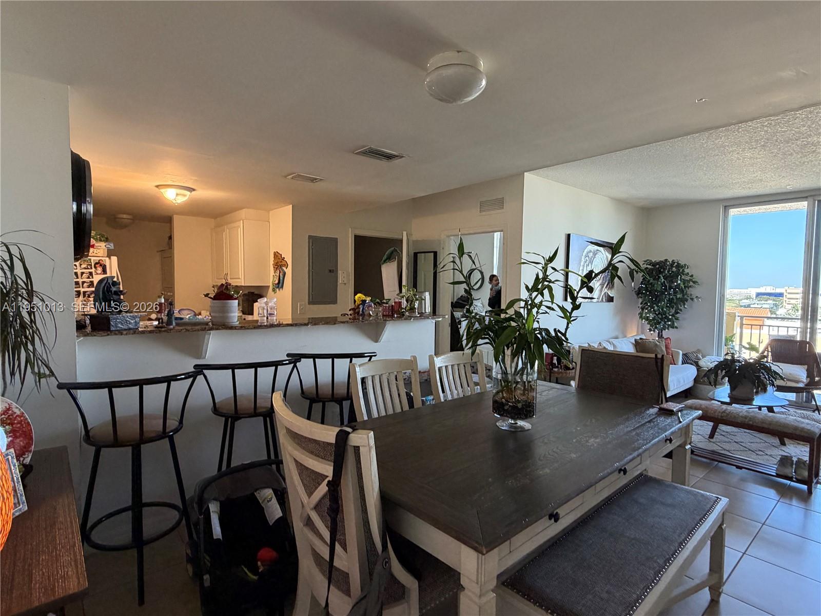 215 Southwest 42nd Avenue, Unit 803 Miami, FL 33134 - Photo 4 of 20 a view of a dining room with furniture and wooden floor