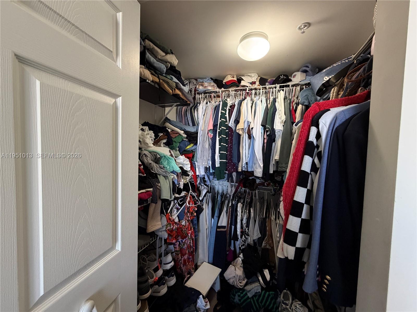 215 Southwest 42nd Avenue, Unit 803 Miami, FL 33134 - Photo 9 of 20 a view of walk in closet with clothes