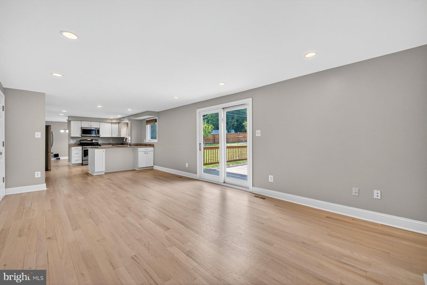 7518 Candytuft Court Springfield, VA 22153 - Photo 15 of 47 a view of empty room with wooden floor and kitchen