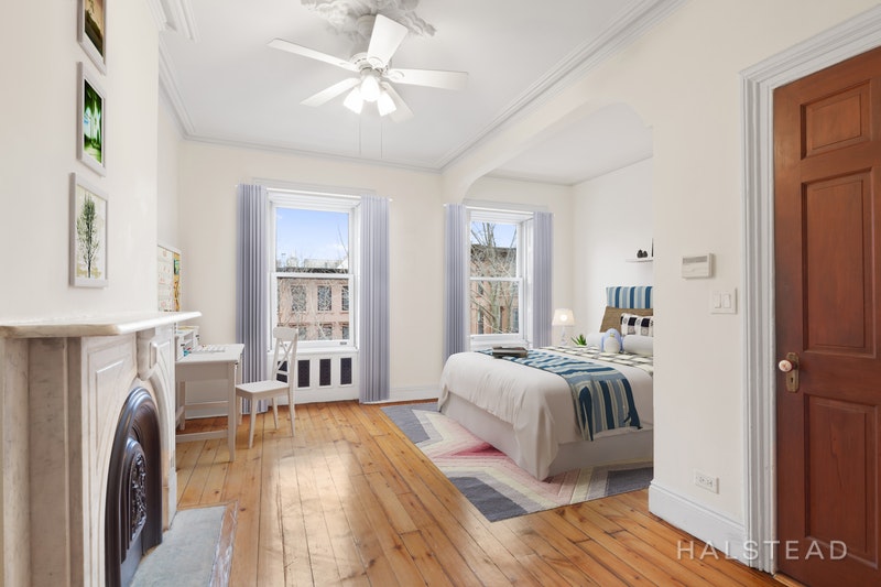 192 6th Avenue Brooklyn, NY 11217 - Photo 11 of 20 a spacious bedroom with a bed and a chandelier