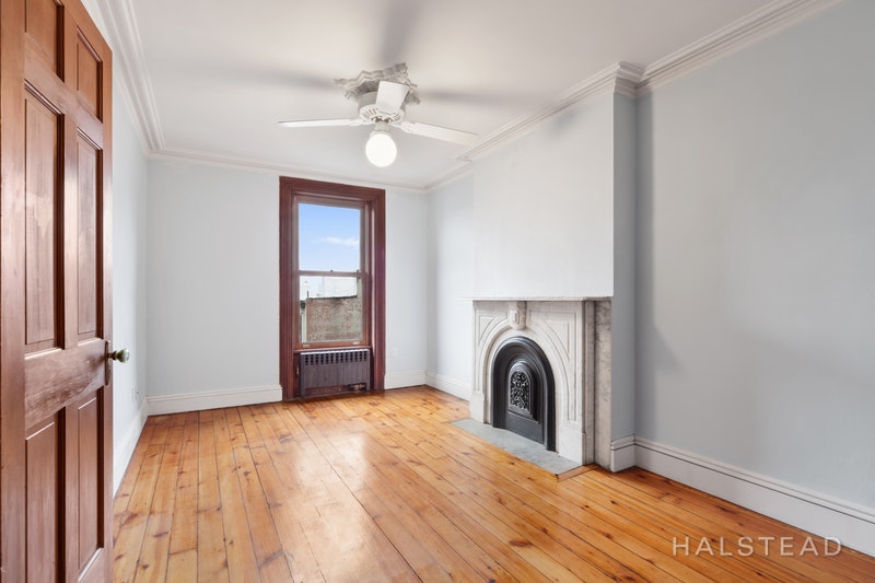 192 6th Avenue Brooklyn, NY 11217 - Photo 14 of 20 a view of a livingroom with a fireplace a ceiling fan and wooden floor