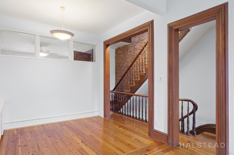 192 6th Avenue Brooklyn, NY 11217 - Photo 16 of 20 a view of a hallway with wooden floor and stairs