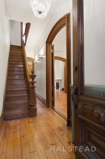 192 6th Avenue Brooklyn, NY 11217 - Photo 17 of 20 a view of a hallway to a livingroom with wooden floor and stairs
