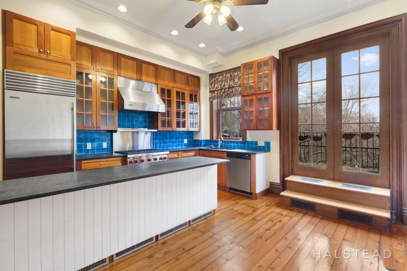 192 6th Avenue Brooklyn, NY 11217 - Photo 6 of 20 a kitchen with stainless steel appliances granite countertop a refrigerator a stove and a sink with wooden floor
