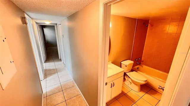 a bathroom with a sink a toilet a tub and shower