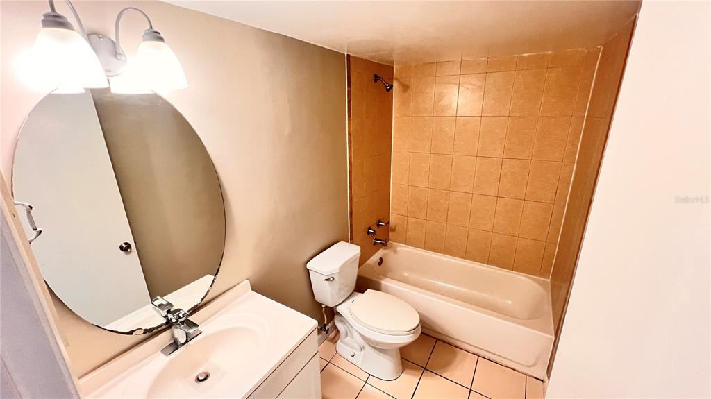 1902 Honour Road, Unit 24 Orlando, FL 32839 - Photo 14 of 25 a bathroom with a sink a toilet a tub and shower