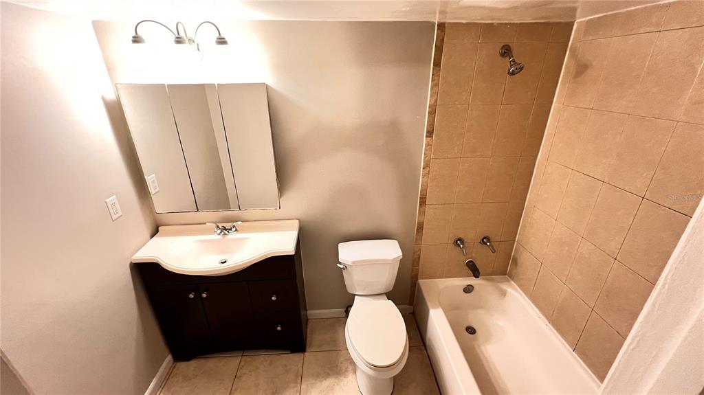 1902 Honour Road, Unit 24 Orlando, FL 32839 - Photo 24 of 25 a bathroom with a toilet sink and mirror