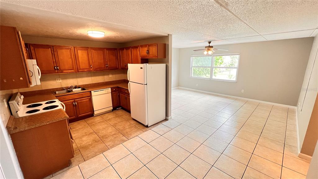 1902 Honour Road, Unit 24 Orlando, FL 32839 - Photo 4 of 25 a kitchen with stainless steel appliances granite countertop a refrigerator sink and stove